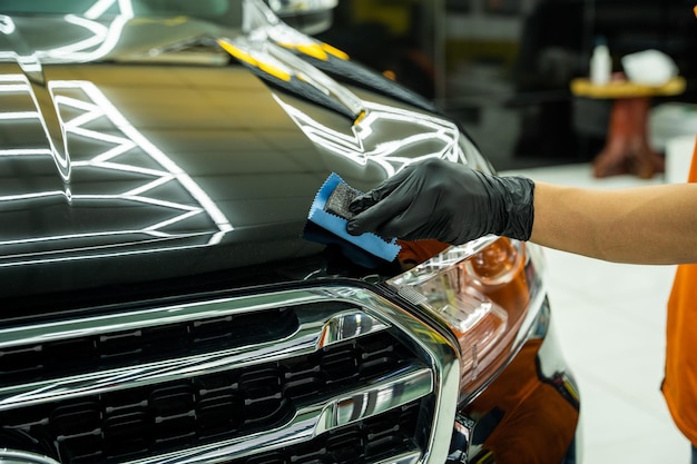 Man's hand is taking care of car maintenance at garage