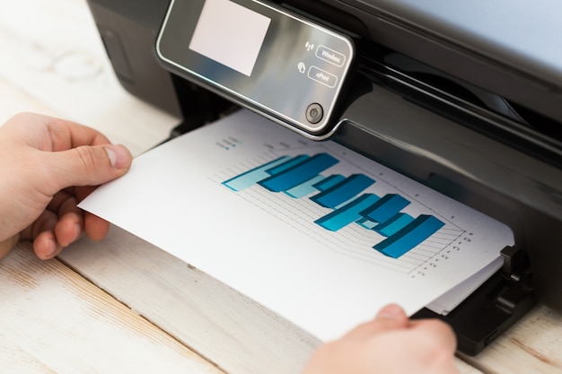 Man's hand making copies. Working with printer