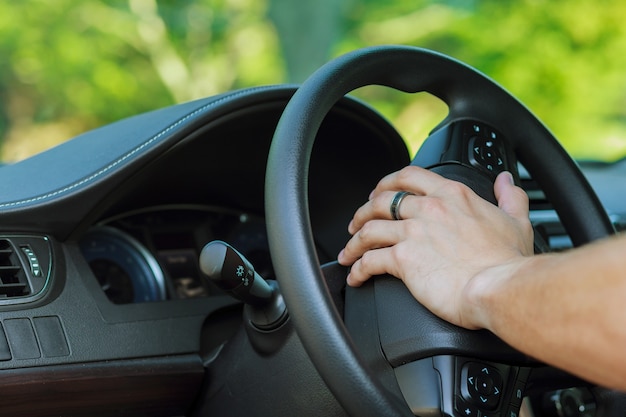 Photo man's hand on the steering wheel of a car wheel driver car