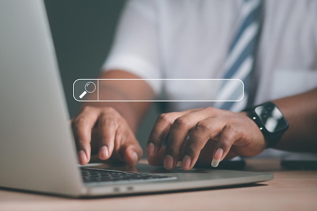 Photo man's hand using computer keyboard to search for information using search on your website