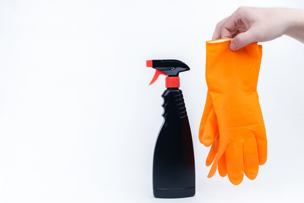 A man's hand with rubber gloves and cleaning agent. Protection and disinfection concept