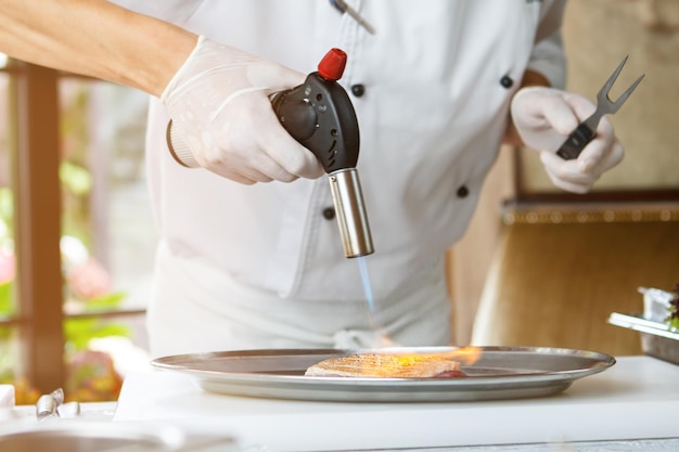 Man's hand with torch burner.