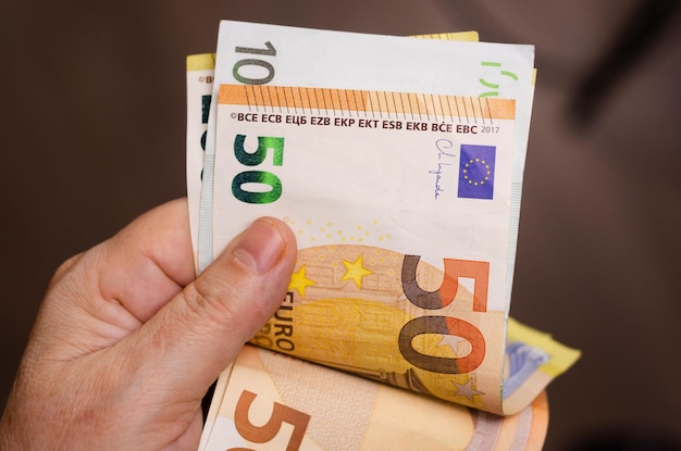 Man's hands counting euro banknotes. Close-up of male hands counting money.