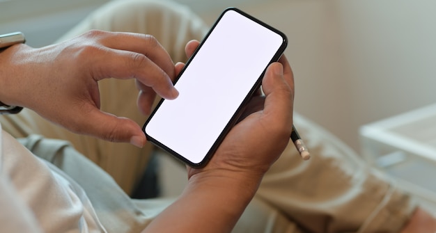 Man's hands holding blank screen smartphone 