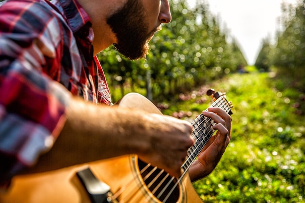 Man's hands playing acoustic guitar close up Acoustic guitars playing Music concept Guitars acoustic Male musician playing guitar music instrument