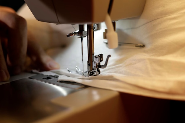 man's hands sewing on sewing machine