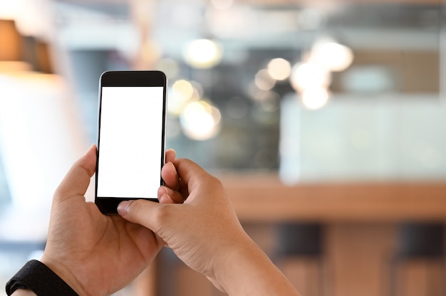 Man's hands using Smartphone with blank screen.