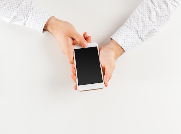 Man's hands using smartphone