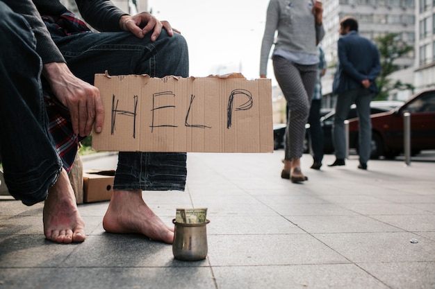 Man's legs without shoes standing on the concrete ground