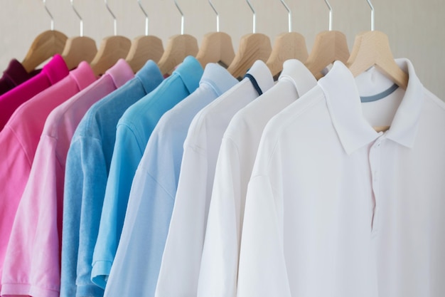 Man's shirts hanging on rack in row