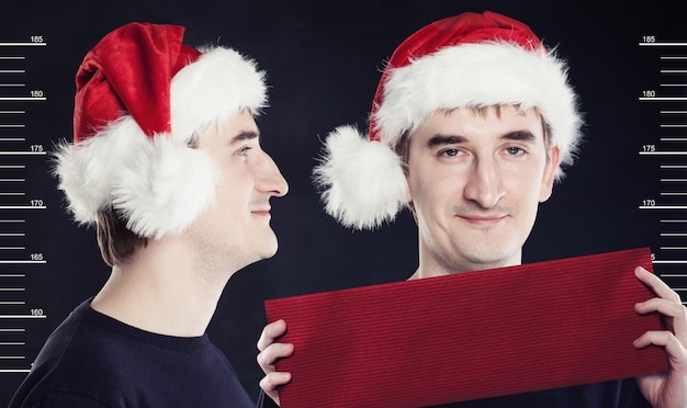 man in Santa Claus hat posing in a prison. Concept santa search