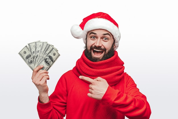 man in Santa hat showing bunch of money