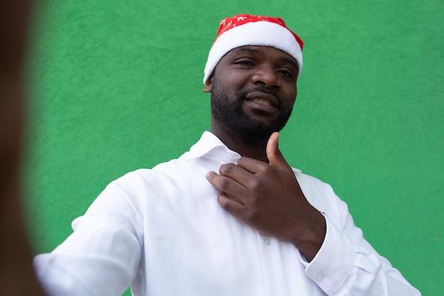 A man in Santa's hat takes a selfie