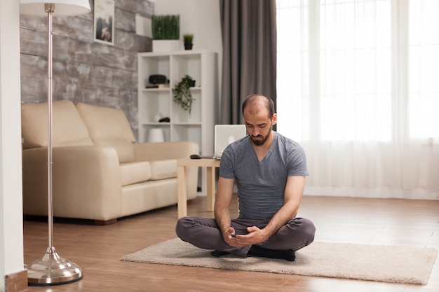 Man scrolling on smartphone during covid-19 in living room.