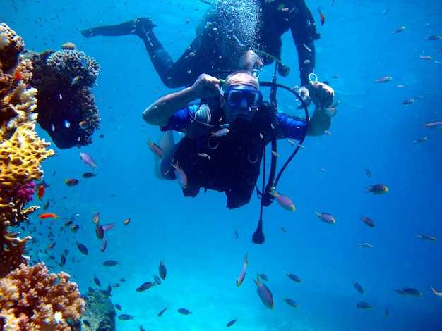 Man scuba diver and beautiful colorful coral reef underwater.