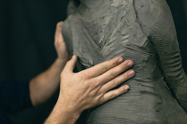 Man sculptor creates sculpt bust clay human woman sculpture Statue craft creation workshop