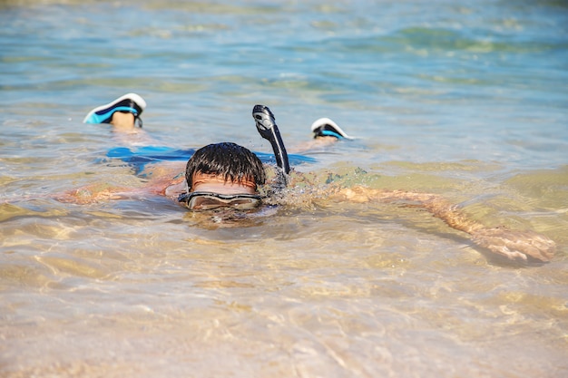 A man at the sea in fins and mask. 