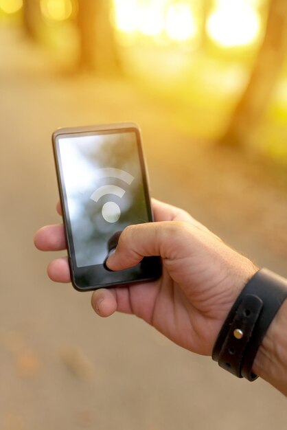 Man searching for mobile GPS signal in the woods