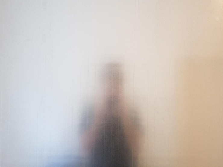 Photo man seen through glass