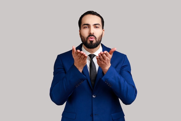 Man sending air kiss over palms flirting to camera demonstrating romantic amorous feelings