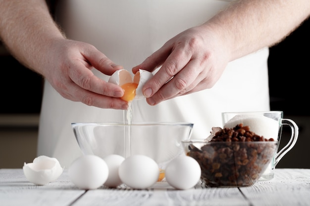 man separating the yolk from the egg white