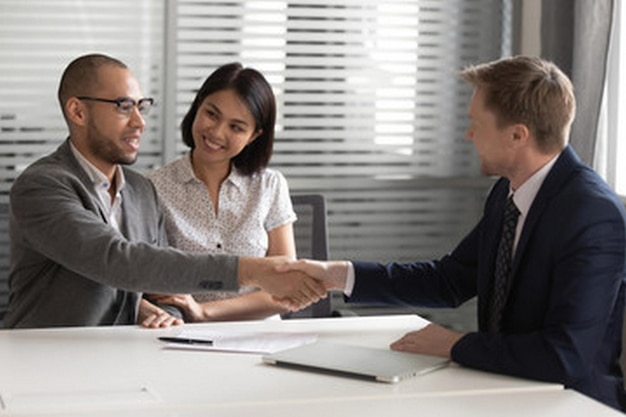 a man shaking hands with a woman shaking hands