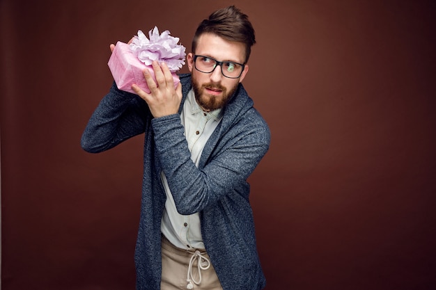 Man shaking small present box