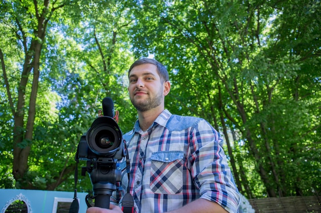 A man in a shirt with a monopod and a camera