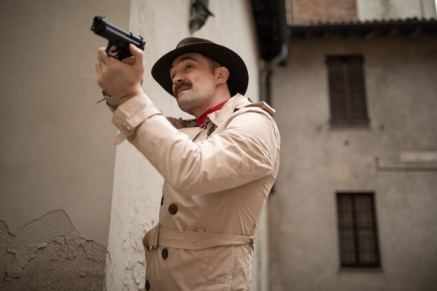 Man shooting a gun in a skid row