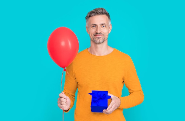 Man shopper with present and balloon on background photo of man shopper with present