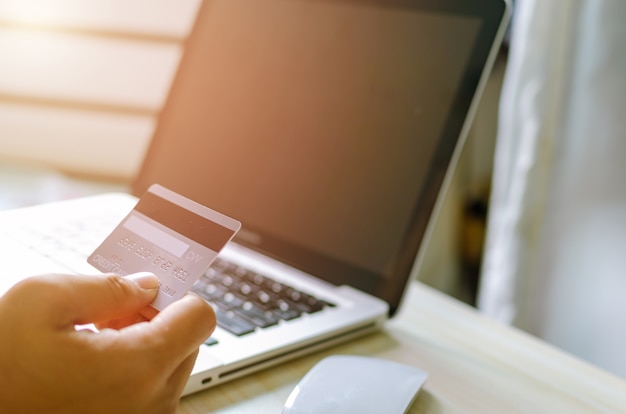 Man Shopping Online Using Laptop With Credit Card