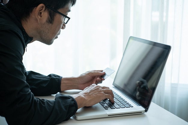 Man shopping online via laptop computer and pay by credit card