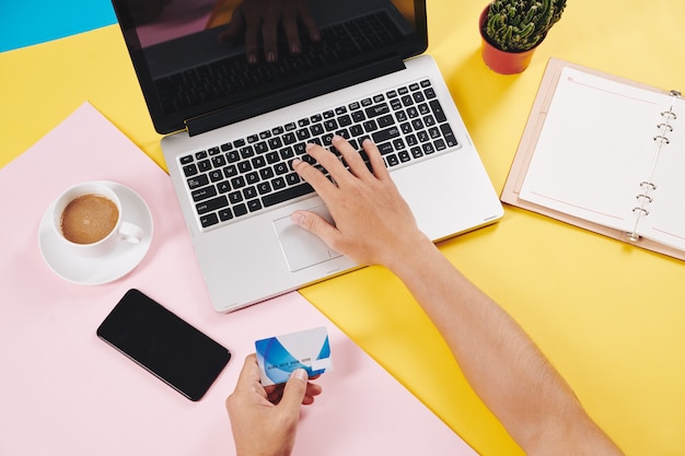 Man shopping online with credit card