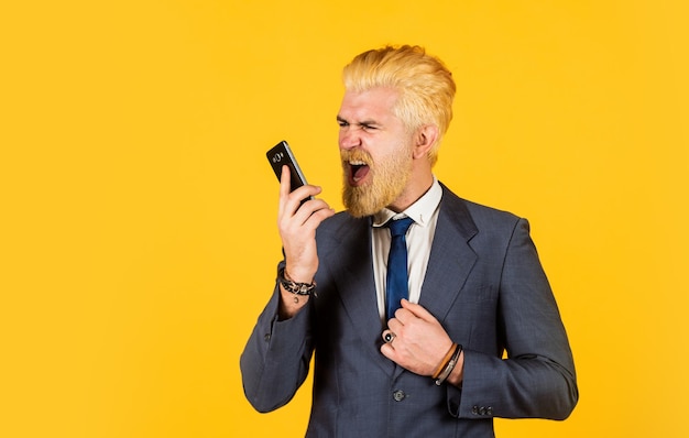 Man shout on someone while speaking Successful boss ceo and entrepreneurship Full concentration at work business discussion businessman speak on phone bearded man dyed hair wear jacket