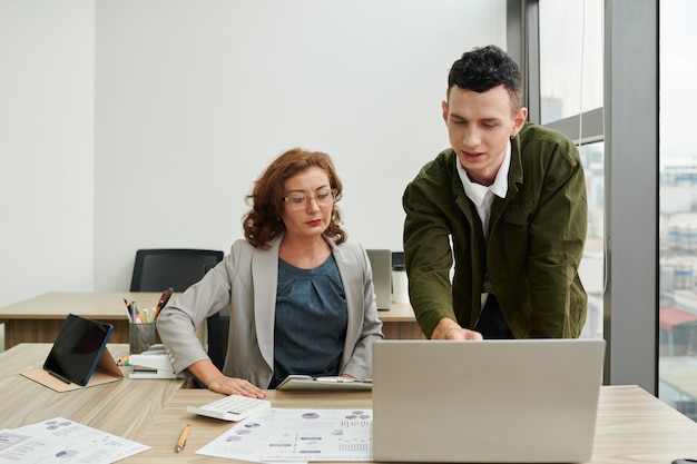 Man Showing Charts to Skeptical Manager