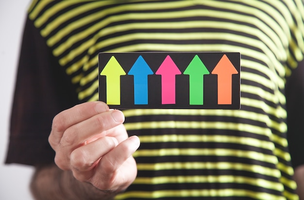 Man showing colorful arrows.