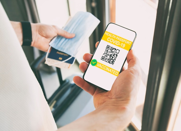 L'uomo che mostra l'app del passaporto sanitario digitale nel telefono cellulare per i viaggi.