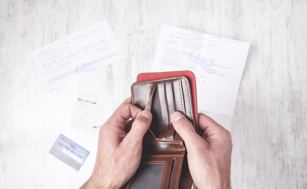 Man showing empty wallet. Financial problem