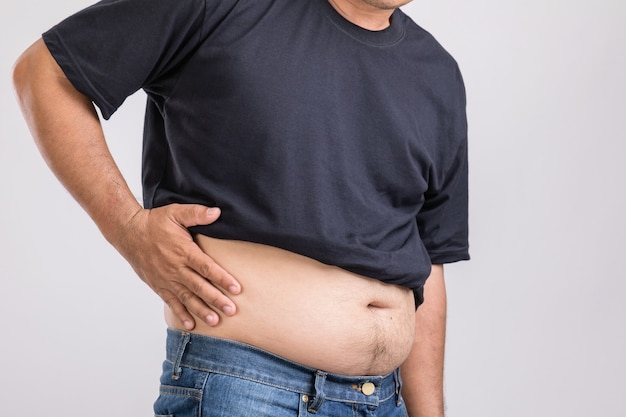 Man showing his big belly and pain