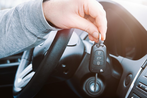 man showing his new car key buying or rent a car