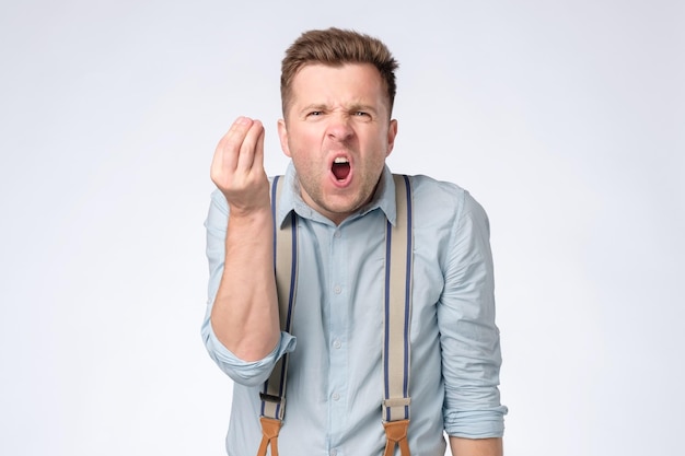 Man showing italian gesture that means what do you want trying to prove his point of view