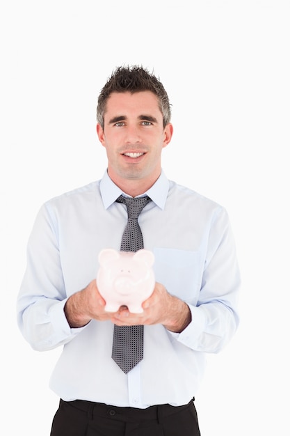 Man showing a piggy bank