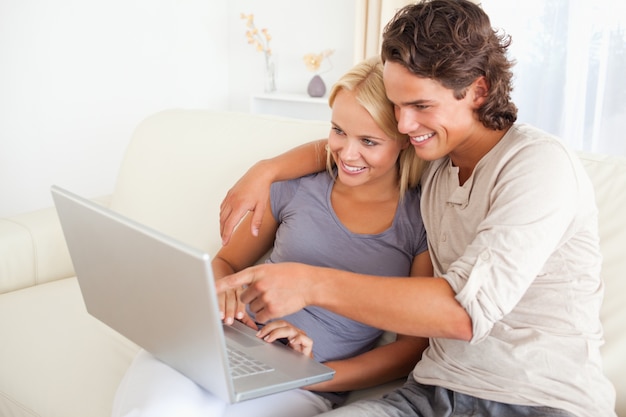 Man showing something to his wife on a screen