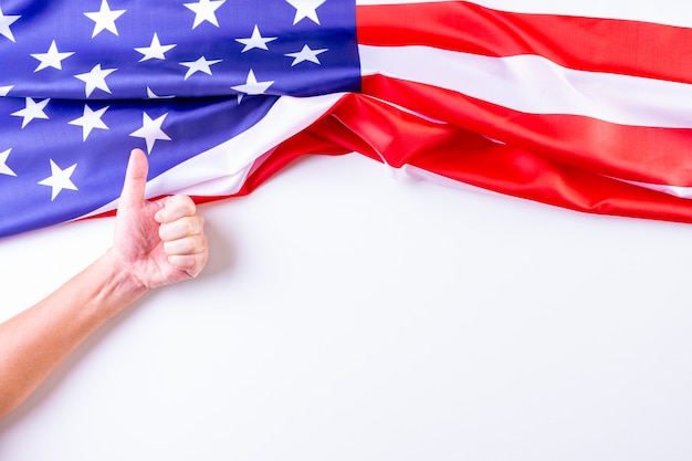 Man showing thumbs up over American flags.