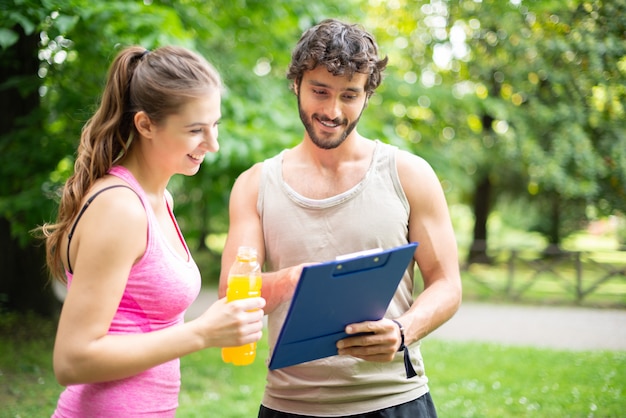 Man showing a training table to a woman