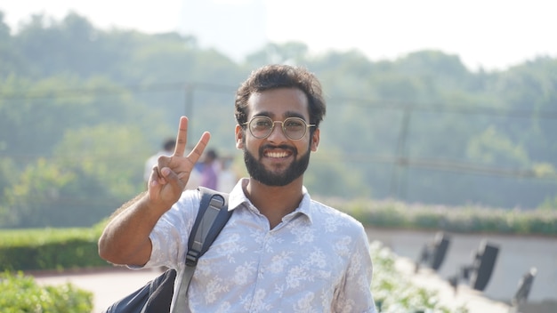 A man showing victory sign