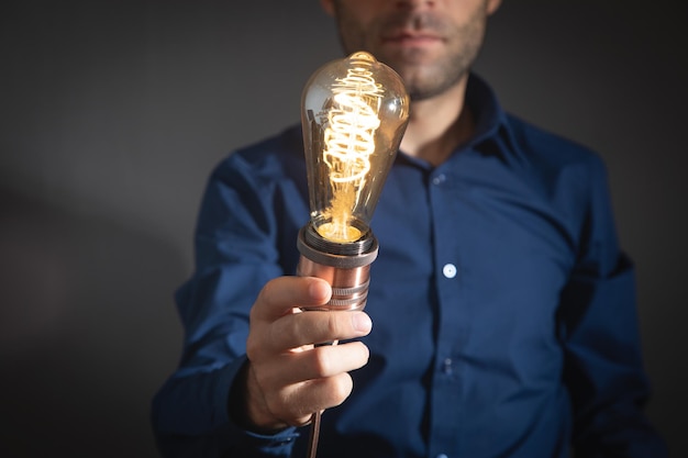 Man showing vintage modern light bulb