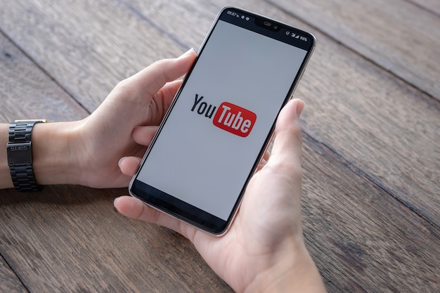 Фото Человек показывает приложение youtube на смартфоне