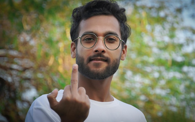 Man shows hand gesture fuck off to camera. Middle finger,