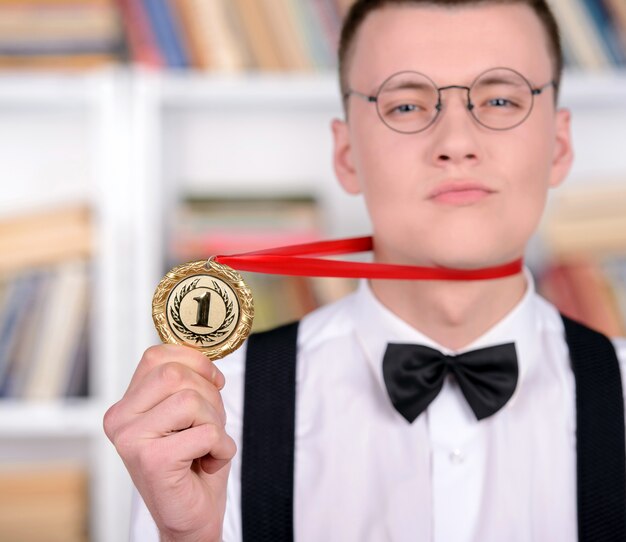 Man shows medal number one and proud.